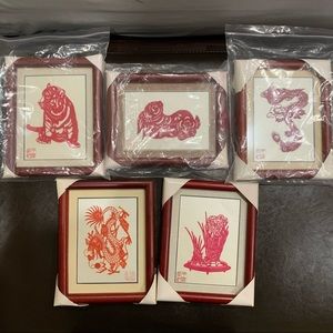 5 framed paper cut-out animals and a plant.